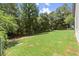 A spacious backyard showcasing a well-maintained lawn, mature trees, and ample space for outdoor activities at 270 Piedmont Ne Rd, Marietta, GA 30066