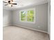 This is a bright bedroom with a ceiling fan and a window overlooking greenery at 270 Piedmont Ne Rd, Marietta, GA 30066