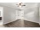 Bright bedroom featuring wood-look floors, a ceiling fan, white trim, and access to a bathroom and closet at 270 Piedmont Ne Rd, Marietta, GA 30066