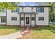 Inviting two-story home featuring a covered front porch, well-manicured lawn, and stone walkway at 270 Piedmont Ne Rd, Marietta, GA 30066