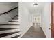 Entryway with stairs, gray walls, and wood-look floors leading to a bright room with French doors at 270 Piedmont Ne Rd, Marietta, GA 30066