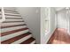 Stairway with wood treads and white risers alongside hallway with hardwood flooring at 270 Piedmont Ne Rd, Marietta, GA 30066