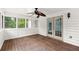 Relaxing sunroom with ceiling fan, wood floor, and backyard views through large windows at 270 Piedmont Ne Rd, Marietta, GA 30066