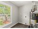 Bright utility room with a large window, modern water heater, and wood-look flooring at 270 Piedmont Ne Rd, Marietta, GA 30066