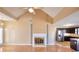 Bright and airy living room featuring a fireplace, vaulted ceiling, and adjacent kitchen at 3500 Patrick Manor Dr, Loganville, GA 30052