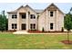 Charming two-story brick home featuring a well-manicured lawn and inviting entrance at 221 Lotus Ln, Covington, GA 30016