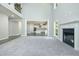 Spacious living room featuring fireplace, tall ceilings, and an open layout to the kitchen at 221 Lotus Ln, Covington, GA 30016