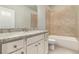 Bathroom features a tub, toilet, and vanity with granite counters and white cabinets at 2402 Palladian Manor Se Way # 3, Atlanta, GA 30339