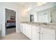 Bathroom with double vanity, granite countertop and a large mirror, adjacent to bedroom at 2402 Palladian Manor Se Way # 3, Atlanta, GA 30339