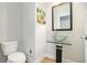 Modern powder room with sleek vanity and vessel sink atop a glass shelf at 2402 Palladian Manor Se Way # 3, Atlanta, GA 30339