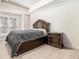 Bedroom with large bed, side table, carpeted floors and a large window for natural light at 2402 Palladian Manor Se Way # 3, Atlanta, GA 30339
