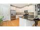 Well-lit kitchen with stainless steel appliances, stone countertops and white cabinetry at 2402 Palladian Manor Se Way # 3, Atlanta, GA 30339