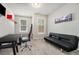 Well-lit office space with desk, futon, and ample natural light, perfect for a home office at 2402 Palladian Manor Se Way # 3, Atlanta, GA 30339