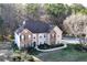 Aerial view of a beautiful two-story brick home featuring lush landscaping and a welcoming front entrance at 3920 Vine Gate Dr, Lithonia, GA 30038