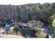 Aerial view of a charming home nestled on a large, wooded lot in a serene neighborhood at 3920 Vine Gate Dr, Lithonia, GA 30038