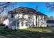 Back of house featuring a patio area surrounded by a beautiful lawn and mature trees at 3920 Vine Gate Dr, Lithonia, GA 30038