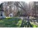 Spacious backyard with mature trees, green grass, and a shed for outdoor storage at 3920 Vine Gate Dr, Lithonia, GA 30038