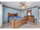 Spacious bedroom featuring a ceiling fan, and light blue walls and wood trim at 3920 Vine Gate Dr, Lithonia, GA 30038