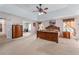 Spacious carpeted bedroom with high ceilings and decorative window coverings at 3920 Vine Gate Dr, Lithonia, GA 30038