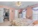 Cozy bedroom with decorative trim, light, and access to a walk-in closet at 3920 Vine Gate Dr, Lithonia, GA 30038