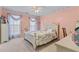 Cozy bedroom with white furniture, carpet, and natural light from windows at 3920 Vine Gate Dr, Lithonia, GA 30038