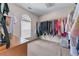 Spacious walk-in closet featuring ample storage and natural light from a window at 3920 Vine Gate Dr, Lithonia, GA 30038