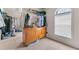 Walk-in closet with lots of hanging clothes and natural light from arched window at 3920 Vine Gate Dr, Lithonia, GA 30038