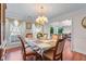 Elegant dining room featuring hardwood floors, a chandelier, and plenty of natural light for a cozy dining space at 3920 Vine Gate Dr, Lithonia, GA 30038