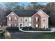 Charming two-story home featuring a brick and stucco facade, well-maintained landscaping, and a welcoming front entrance at 3920 Vine Gate Dr, Lithonia, GA 30038
