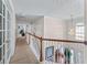 Upstairs hallway overlooking the foyer with a chandelier and large windows providing natural light at 3920 Vine Gate Dr, Lithonia, GA 30038
