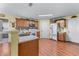 Bright kitchen featuring wooden cabinets, a center island, stainless steel appliances, and wood flooring at 3920 Vine Gate Dr, Lithonia, GA 30038