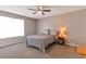 Bright bedroom with neutral walls, cozy carpet, ceiling fan and a window for natural light at 922 Lakewood Ln, Jonesboro, GA 30238