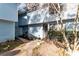Charming townhome featuring blue siding, blooming tree and walkway leading to the front door at 922 Lakewood Ln, Jonesboro, GA 30238