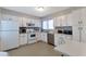 Well-lit kitchen with white cabinets, stainless steel appliances and tile backsplash at 922 Lakewood Ln, Jonesboro, GA 30238