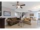 Spacious living room with neutral paint, tile flooring, ceiling fan and staircase at 922 Lakewood Ln, Jonesboro, GA 30238