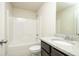 Bright bathroom featuring a shower-tub combination and a granite countertop vanity with modern fixtures at 211 Lotus Ln, Covington, GA 30016