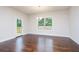 Bright dining room with wood floors, modern lighting, and access to outdoor area at 211 Lotus Ln, Covington, GA 30016