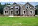 Charming two-story brick home featuring a manicured lawn and multiple windows for abundant natural light at 211 Lotus Ln, Covington, GA 30016