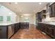 Modern kitchen featuring granite countertops, stainless appliances, and dark cabinetry at 211 Lotus Ln, Covington, GA 30016