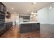Open concept kitchen with granite island, stainless appliances, and hardwood flooring at 211 Lotus Ln, Covington, GA 30016