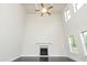 Living room with high ceilings, a cozy fireplace, and abundant natural light from large windows at 211 Lotus Ln, Covington, GA 30016