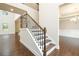 Elegant staircase with iron railing and hardwood steps leading to the second floor at 211 Lotus Ln, Covington, GA 30016