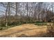 Cozy backyard with gravel area, deck, and mature trees at 58 Knox Rd, Powder Springs, GA 30127