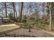 View of the backyard with a wooden deck, pea gravel, and various garden decor at 58 Knox Rd, Powder Springs, GA 30127