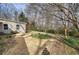 Large backyard space dotted with daffodils and bordered by mature trees at 58 Knox Rd, Powder Springs, GA 30127