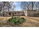 A full view of the house and the backyard with flowers along the back at 58 Knox Rd, Powder Springs, GA 30127