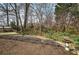 Backyard featuring wooden deck and gravel area surrounded by trees at 58 Knox Rd, Powder Springs, GA 30127