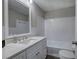 Bathroom features a white vanity with granite countertop, a mirror, and a tub at 58 Knox Rd, Powder Springs, GA 30127
