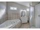 Bathroom with a tile-surround tub, vanity, and separate shower at 58 Knox Rd, Powder Springs, GA 30127