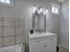Bathroom with a vanity, decorative window, and linen closet at 58 Knox Rd, Powder Springs, GA 30127